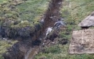 Stone French Drain Install in Ditch Bottom