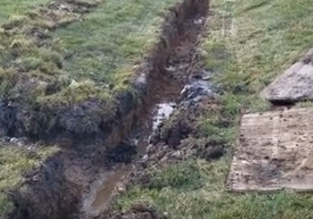 Stone French Drain Install in Ditch Bottom