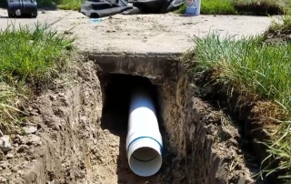 The Correct Way to Run Downspouts Under a Sidewalk